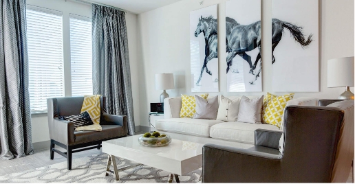 living room with white couch and horse artwork